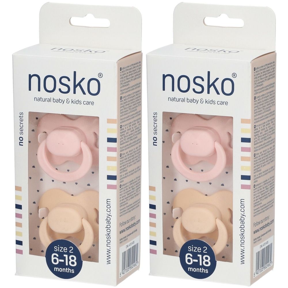 Twee fopspenen in verpakking. Merk: nosko. Roze en beige. Maat 2, voor 6-18 maanden.