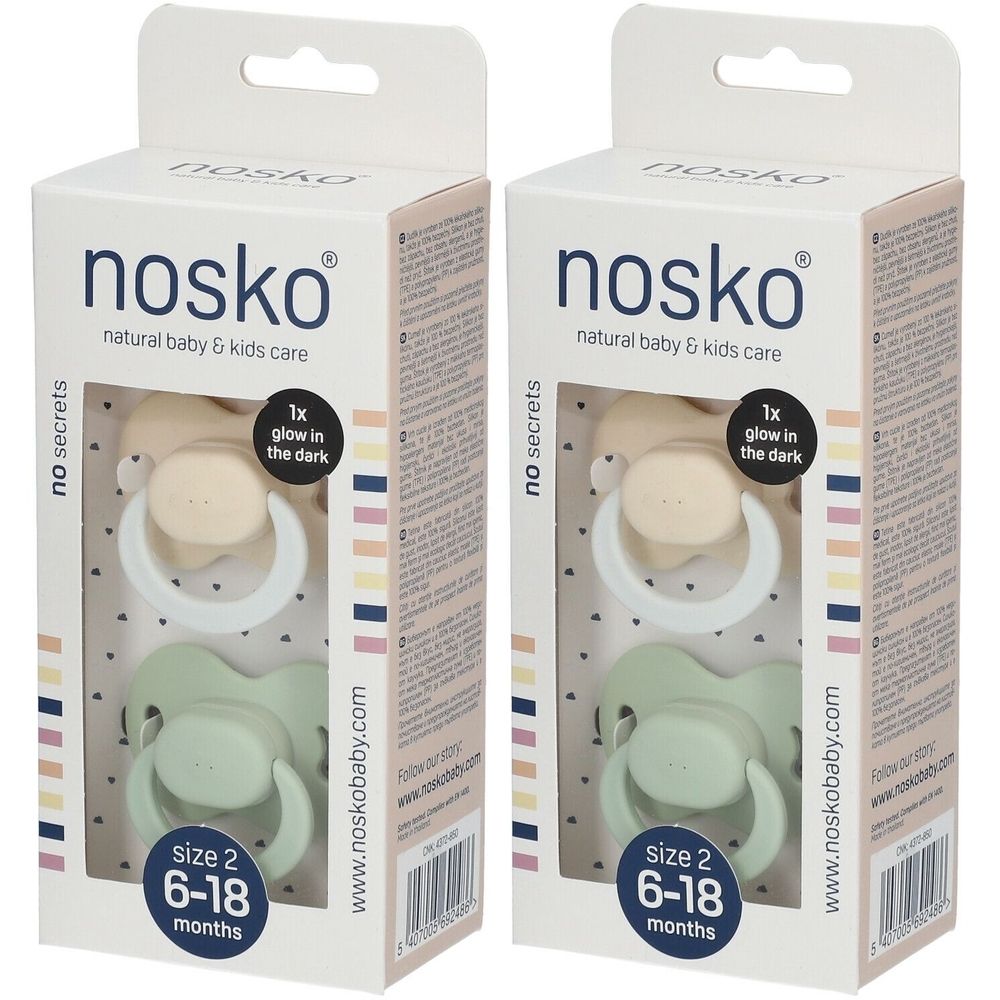Deux boîtes de sucettes. Chaque boîte contient deux sucettes beiges et vertes. Inscription : nosko, 6-18 mois, brille dans le noir.