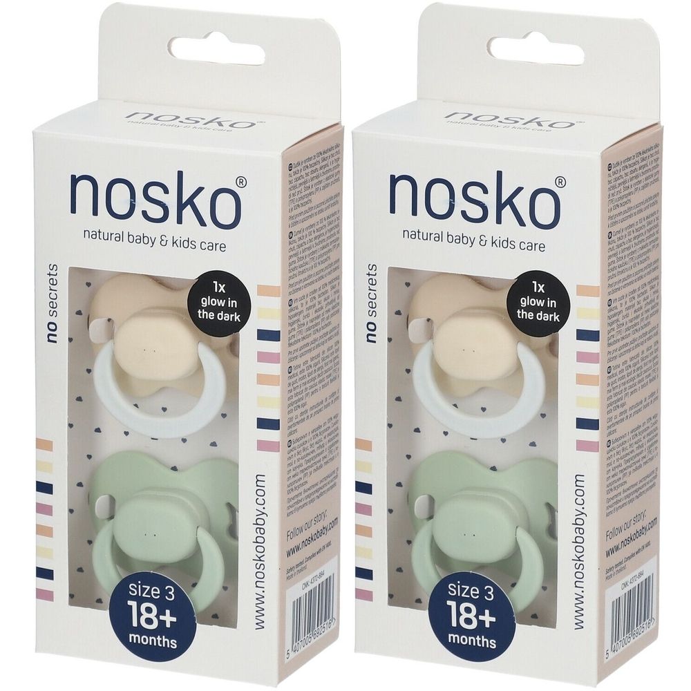 Deux sucettes dans des boîtes. Marque : nosko. Sucettes beiges et vertes. Taille 3, 18 mois et plus. Brille dans le noir.