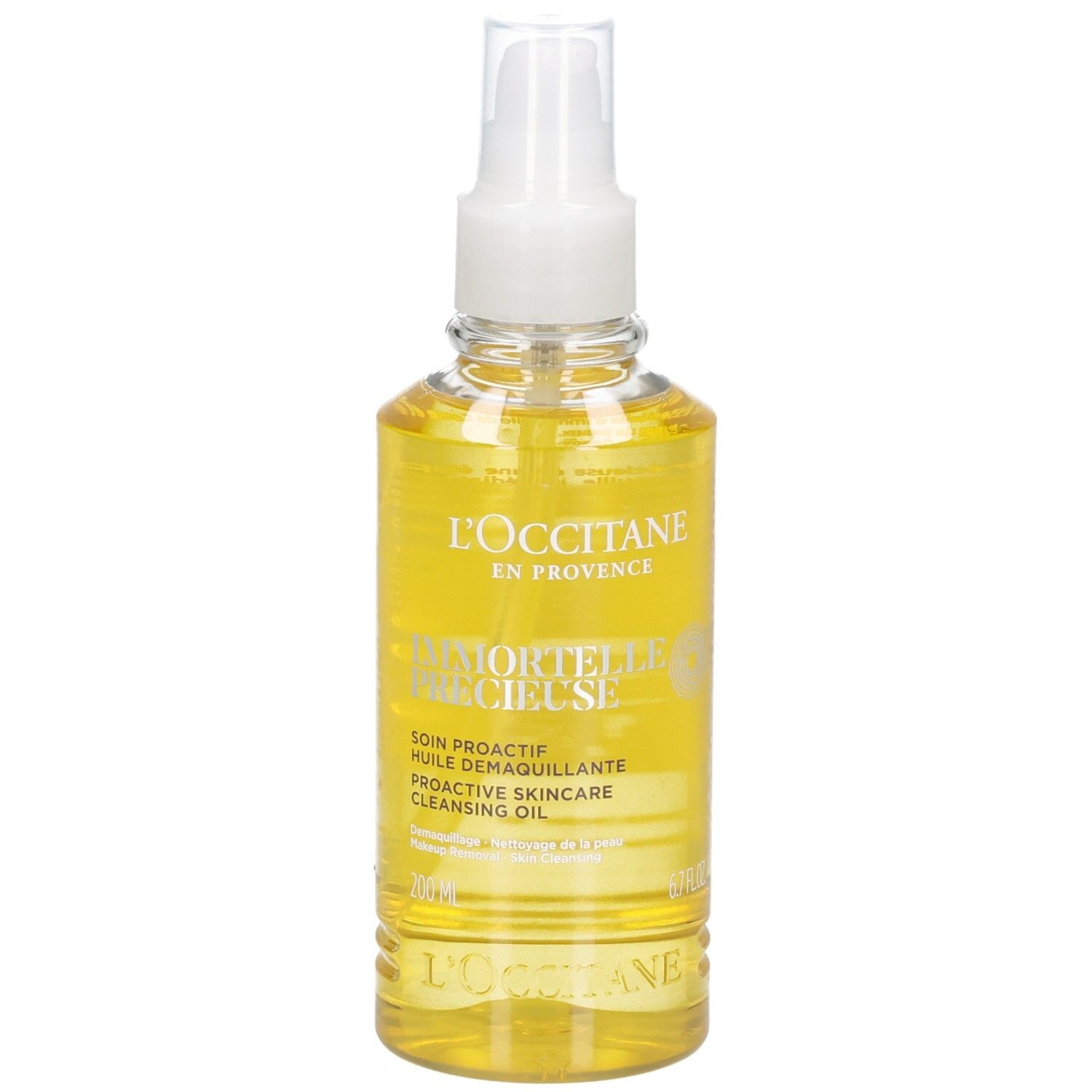 L'OCCITANE Immortelle reinigingsolie in een heldere spuitfles met gele olie.