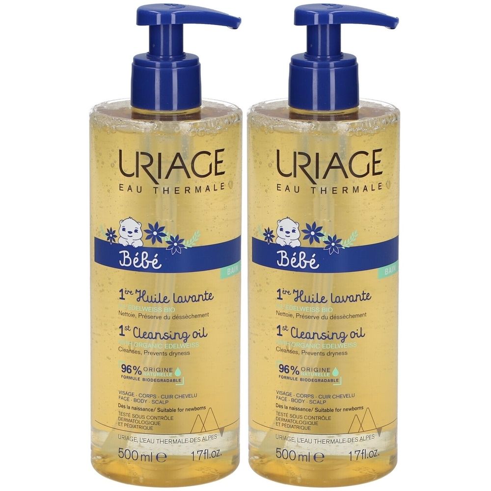 Twee flessen met blauwe pomp. Opschrift URIAGE, Bébé, 1ère Huile lavante, 1er Cleansing oil. 96% origine naturelle. 500ml.