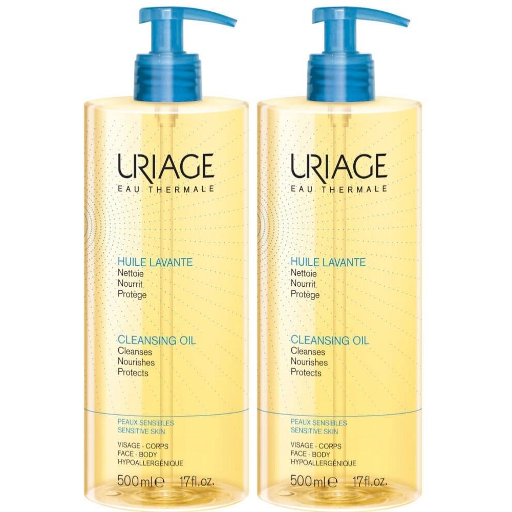 Deux flacons d'huile lavante Uriage avec pompe bleue. Inscription : « Huile Lavante », « Cleansing Oil ». Pour peaux sensibles.