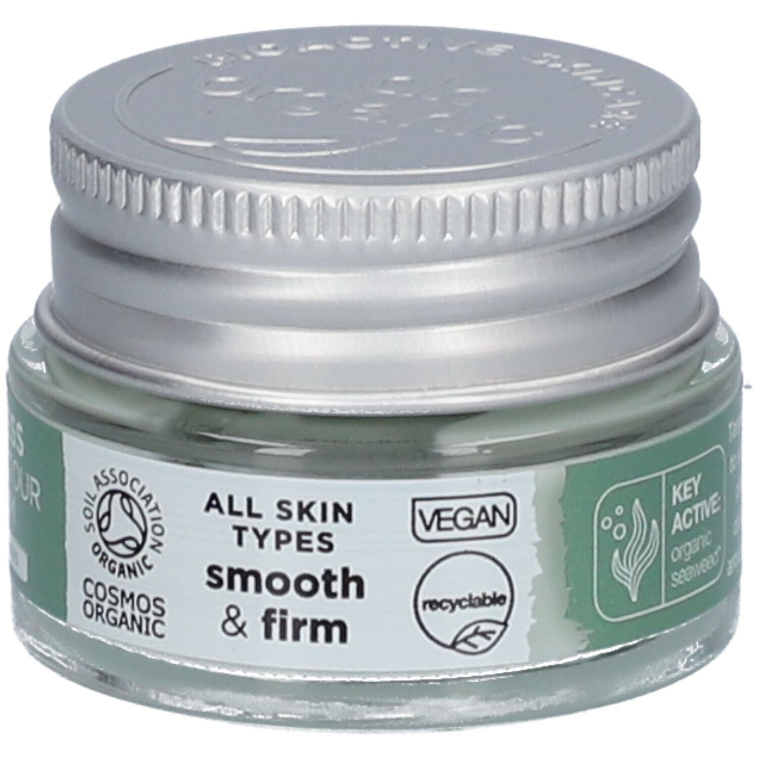 Sérum contour des yeux en pot de verre avec couvercle argenté. Inscription: Ageless Eye Contour Serum. Végétalien. Pour tous types de peau. Recyclable.