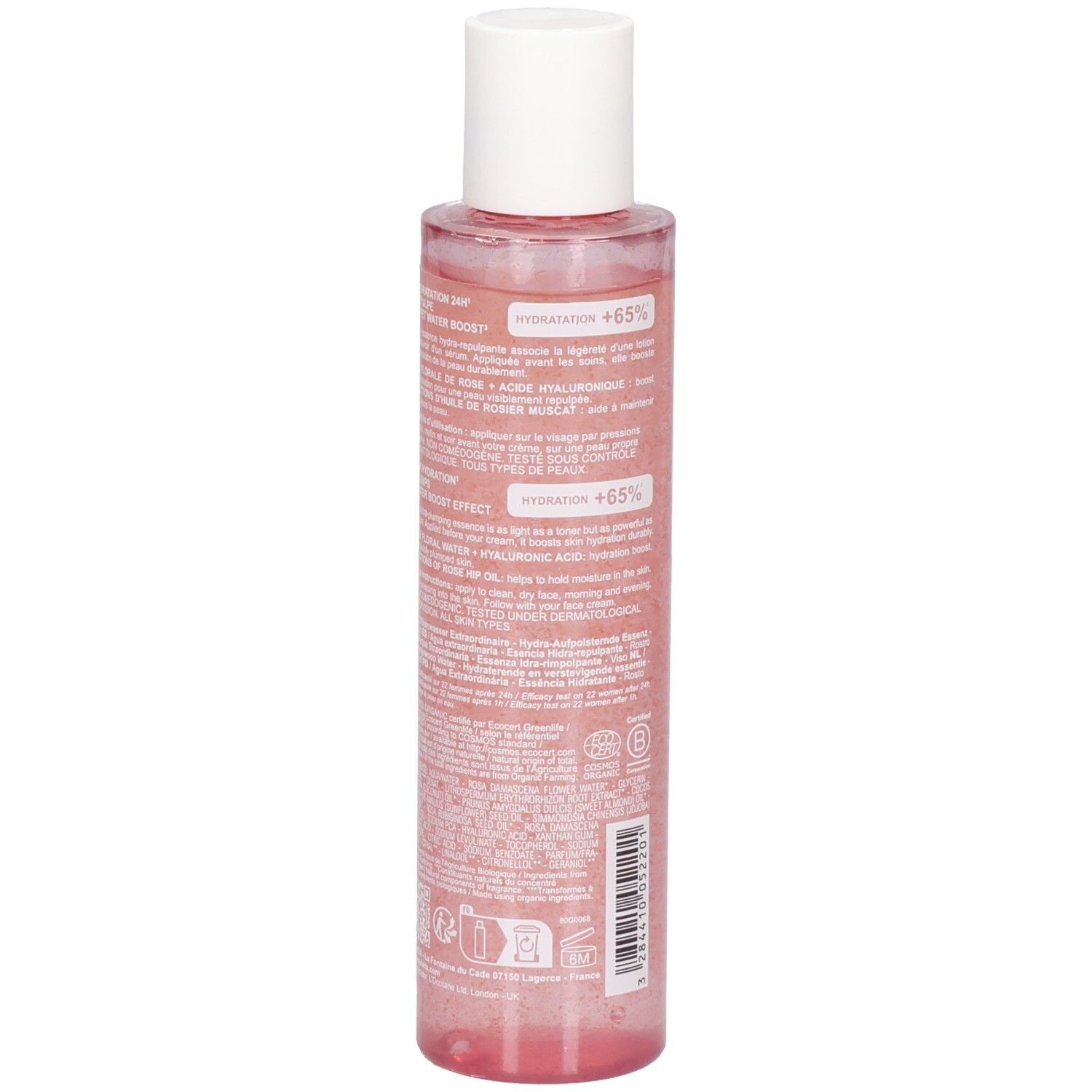 Vue arrière du flacon d'essence de rose. Informations textuelles sur l'étiquette. Flacon transparent avec liquide rose et bouchon blanc.