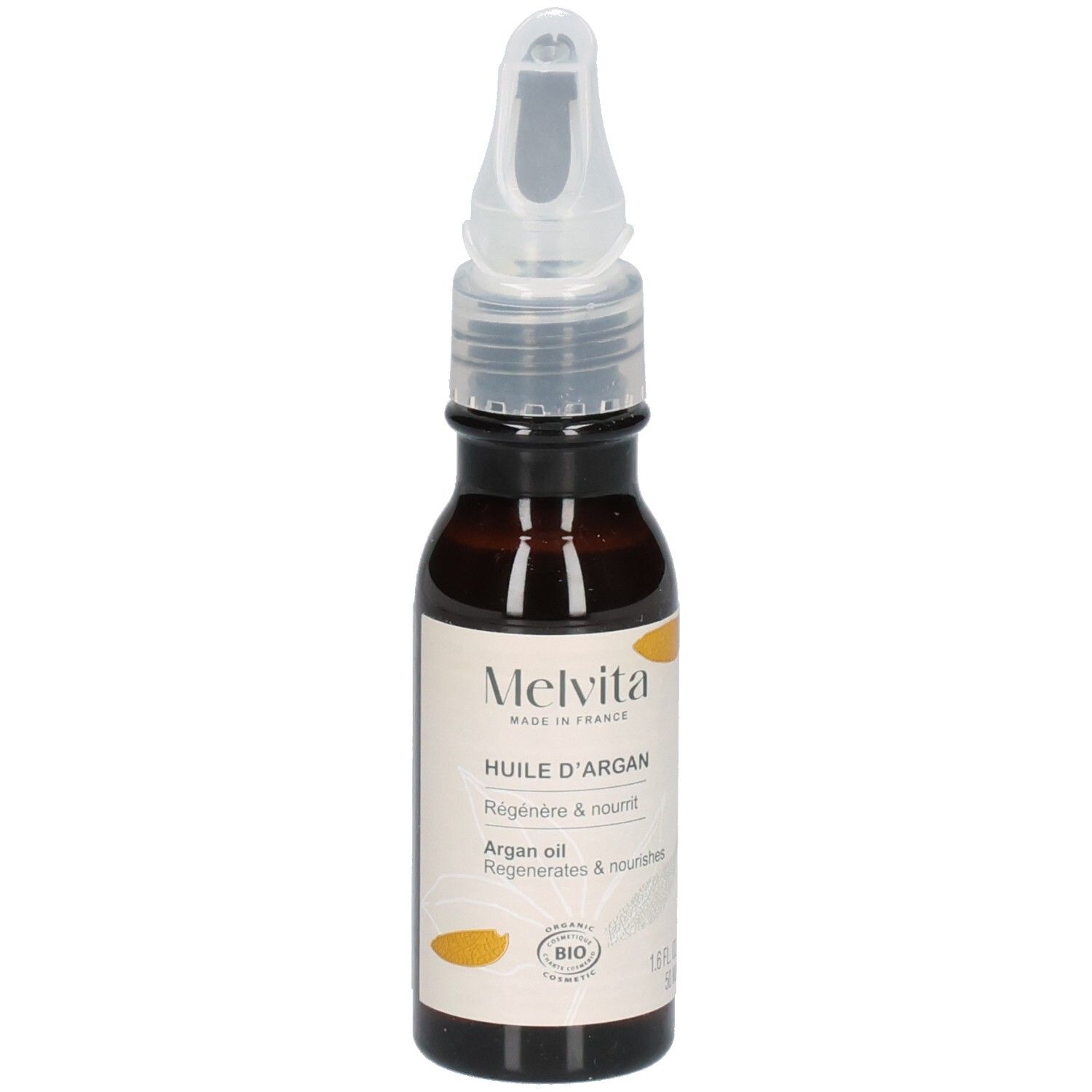 Melvita arganolie fles met applicator, omringd door arganvruchten.