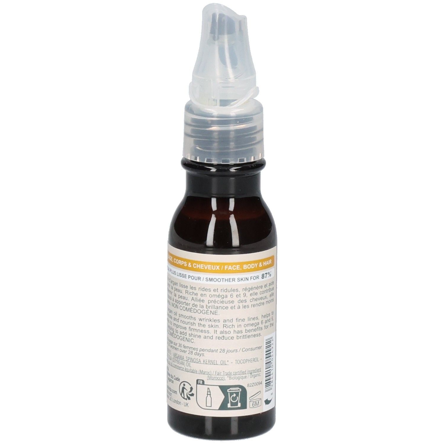 Melvita arganolie fles met applicator, omringd door arganvruchten. "100% puur, koudgeperst".