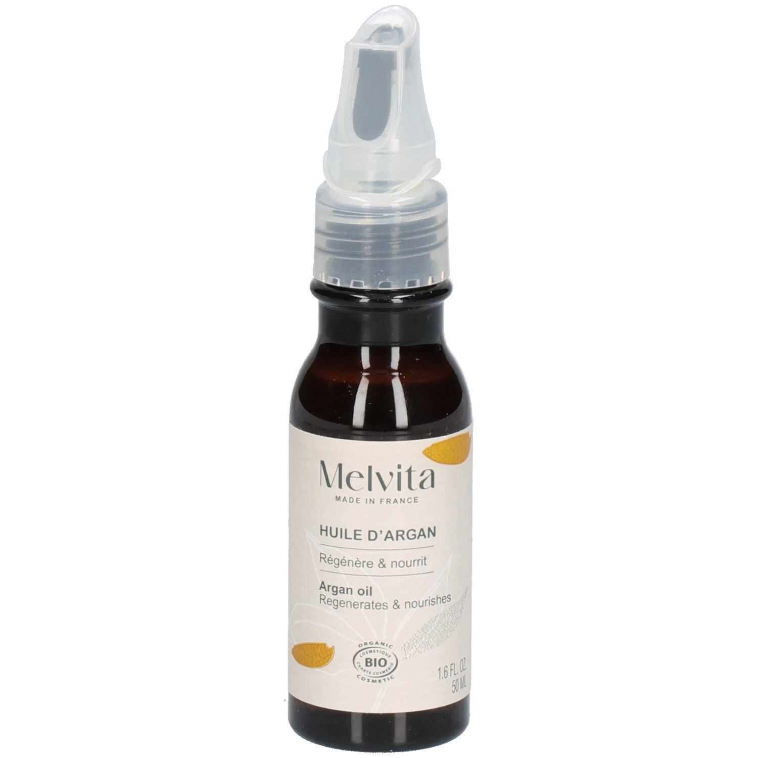 Melvita arganolie fles met applicator op aarde, omringd door planten. "Recyclebare fles".