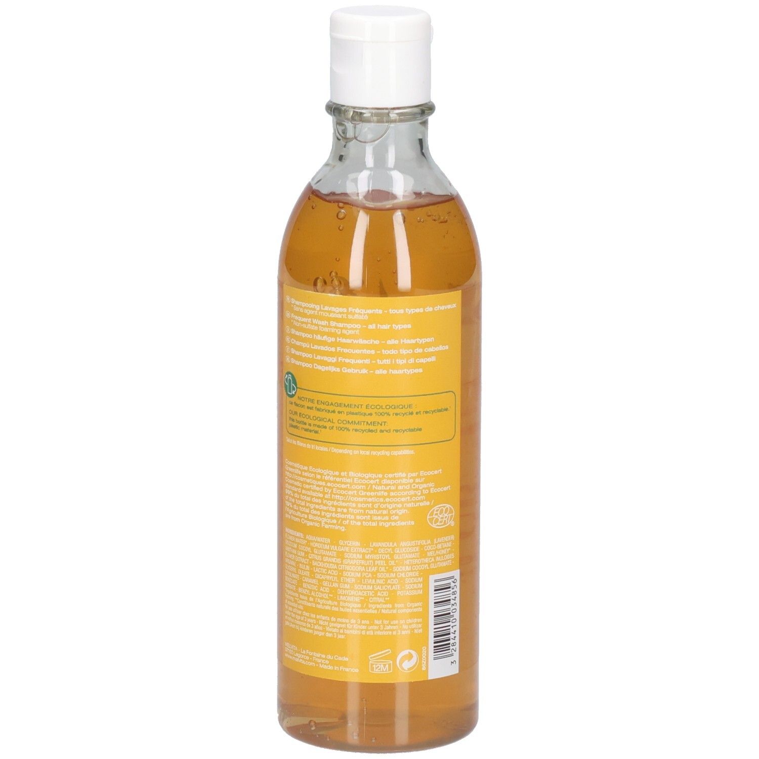 Melvita Shampoo: Grapefruit & Honing, 200ml. Achteraanzicht van de transparante fles met witte dop. Oranje vloeistof.