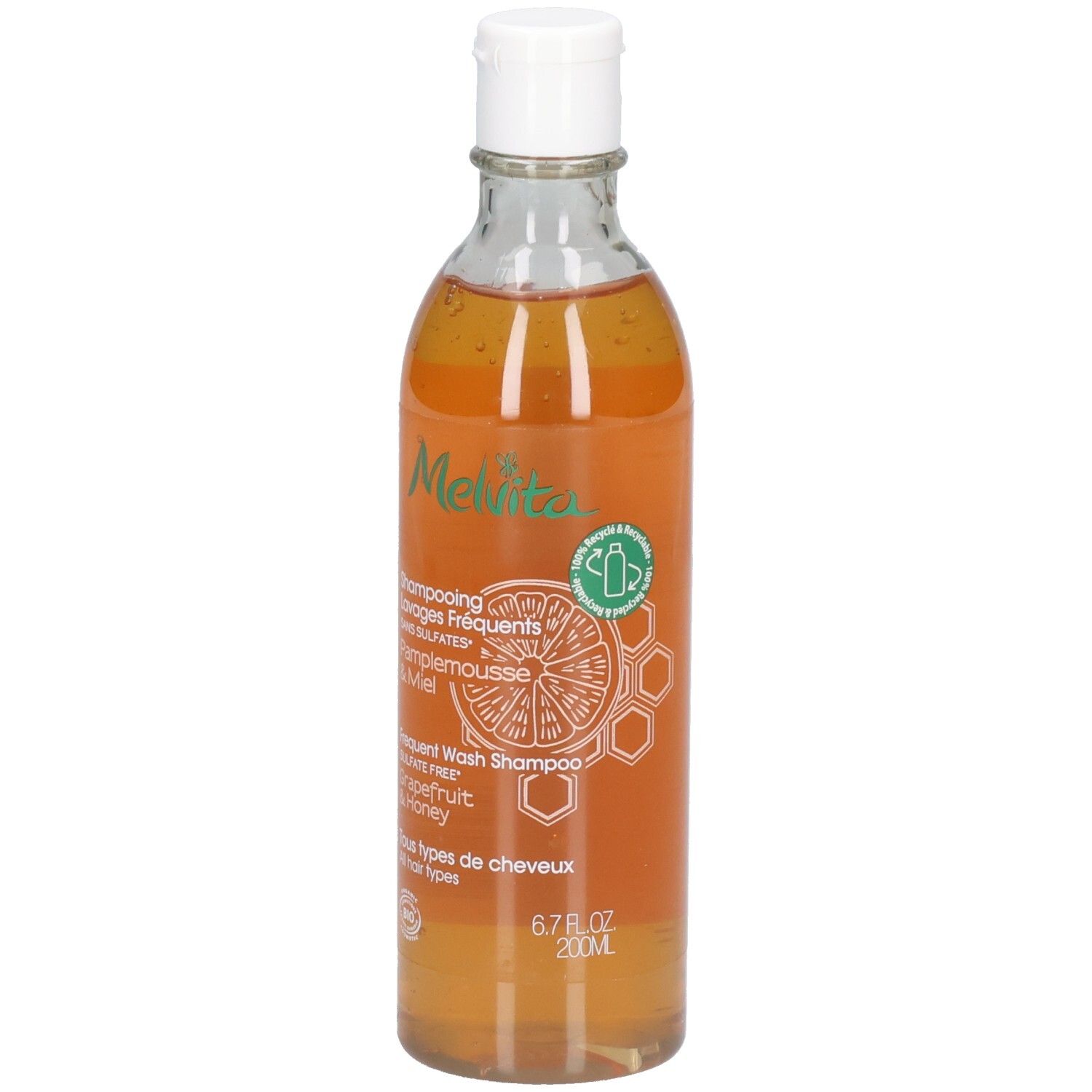 Melvita Shampoo: Grapefruit & Honing, 200ml. Transparante fles met witte dop. Oranje vloeistof.