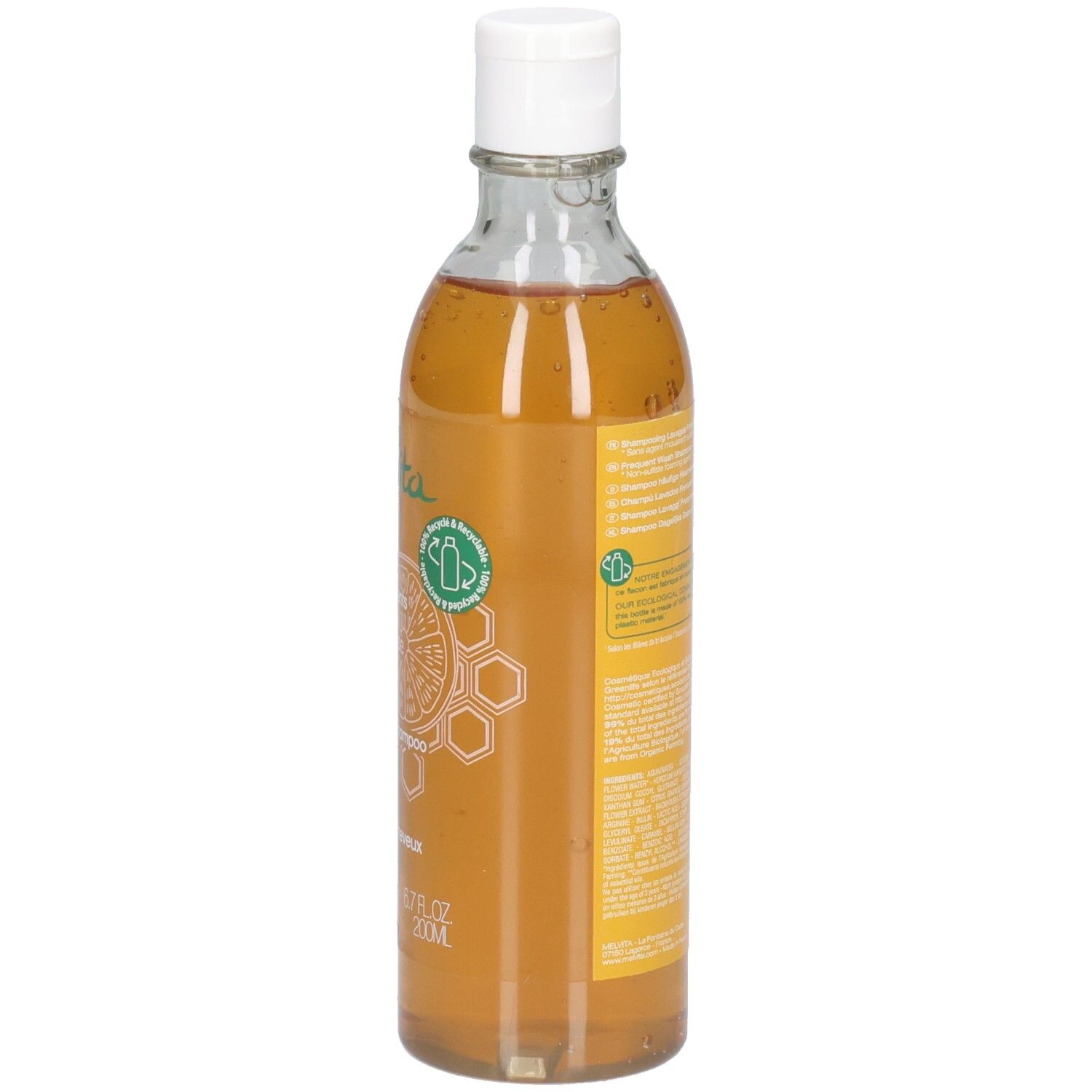 Melvita Shampoo: Grapefruit & Honing, 200ml. Zijaanzicht van de transparante fles met witte dop. Oranje vloeistof.