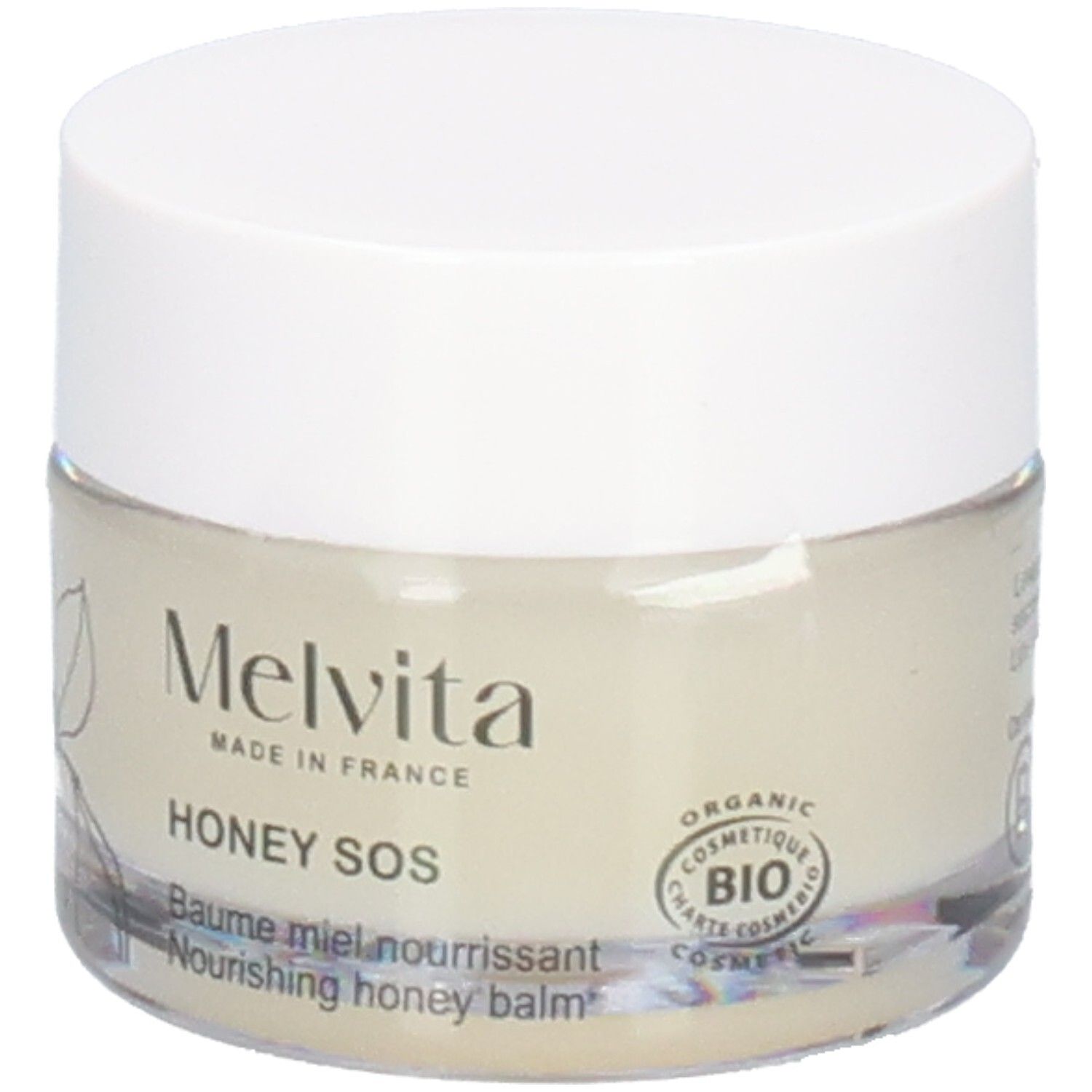 Melvita Honing SOS Balsem: Glazen pot met witte deksel. Voorkant met plantentekening en BIO-zegel.