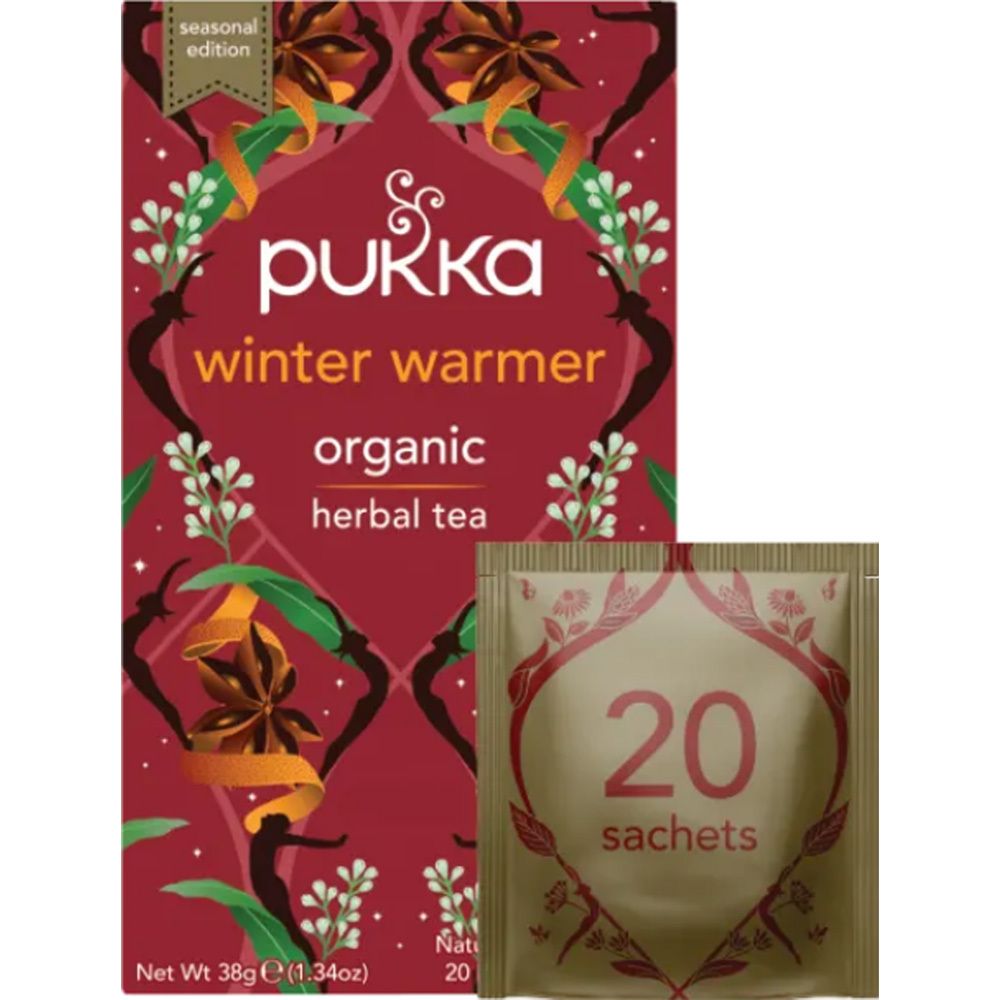 Pukka Winter Warmer theedoos en individuele theezak. Rode verpakking met bloemmotief en productinformatie.