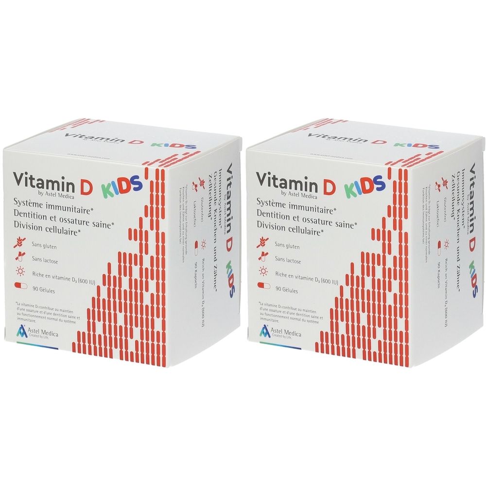 Twee witte dozen met rood patroon en tekst: Vitamin D KIDS. Bevat 90 capsules. Systeem immunitaire, Dentition et ossature saine, Division cellulaire.