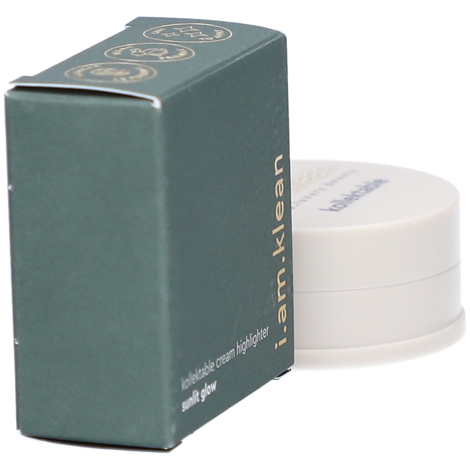 Groene doos en crèmekleurige container. Op de doos staat i.am.klean, kollektable cream highlighter sunlit glow. De container heeft een deksel met tekst.