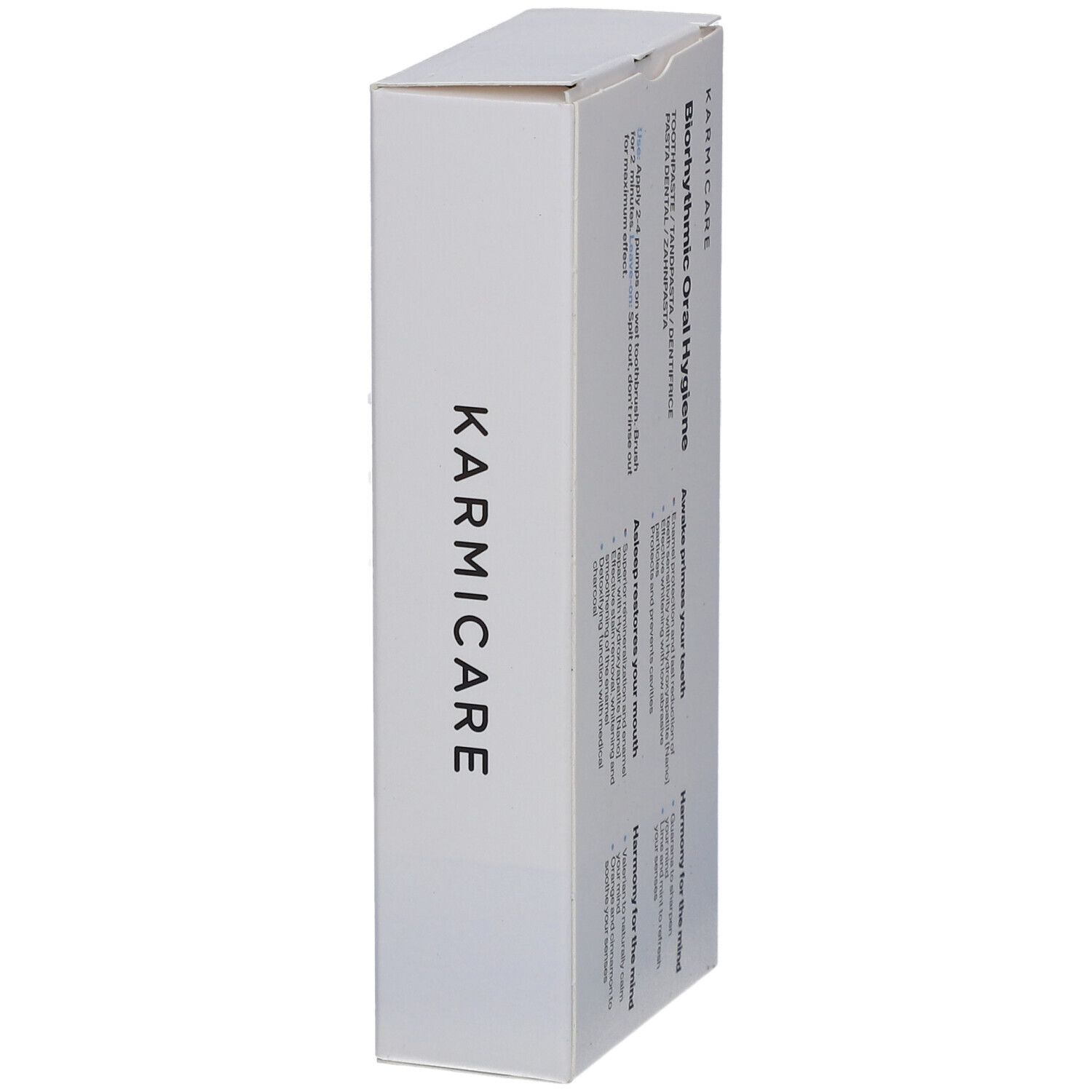 Emballage blanc avec le nom de la marque Karmicare. Texte sur Biorhythmic Oral Hygiene. Sur le côté.