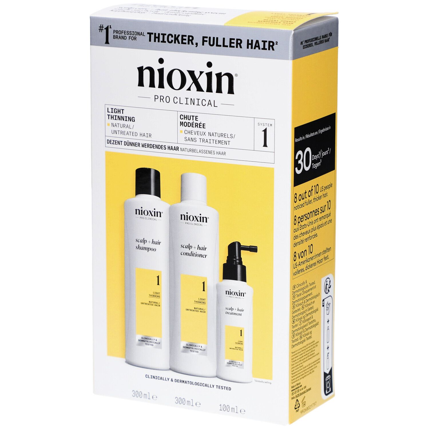 Verpakking met Nioxin shampoo, conditioner en treatment. Witte flessen, gele accenten.