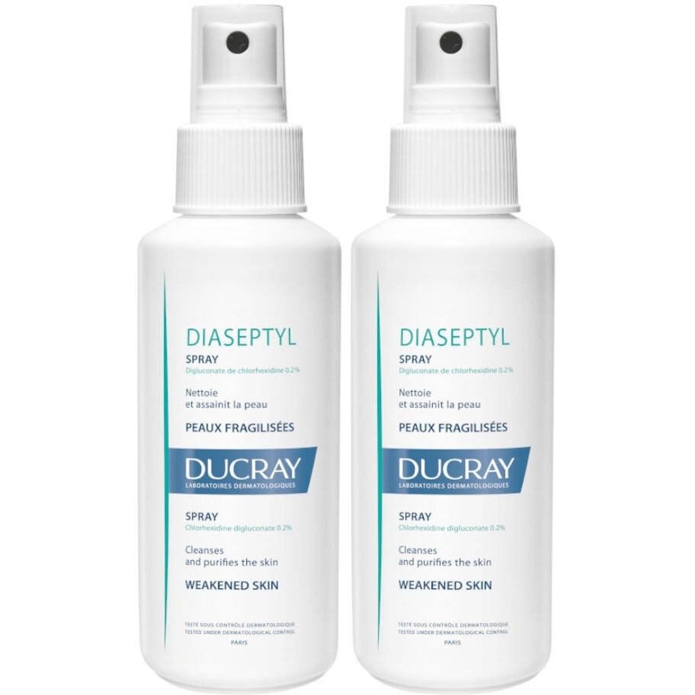 Twee witte sprayflessen met blauwe etiketten. Opschrift: Diaseptyl Spray, Ducray.