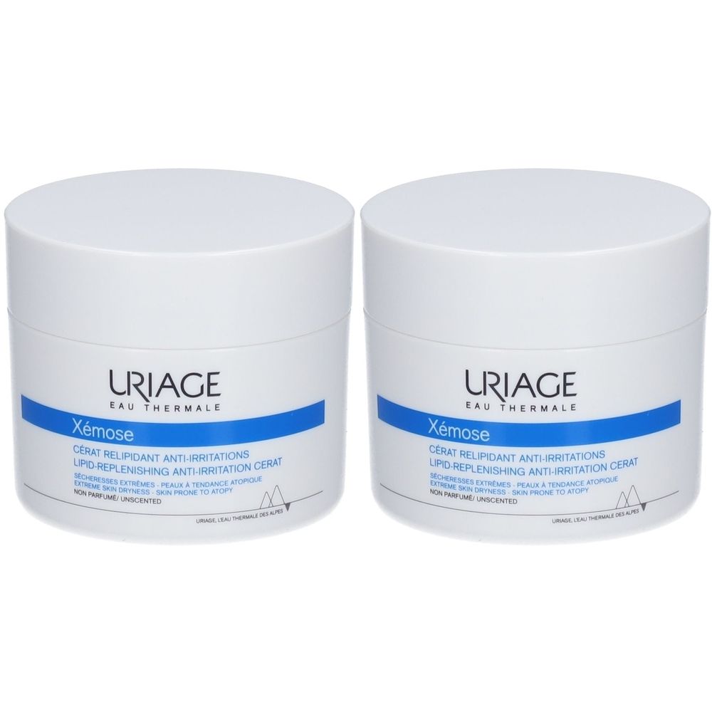 Deux pots blancs URIAGE Xémose. Bandes bleues avec texte. Couvercles. Inscription: Cérat Relipidant Anti-Irritations.