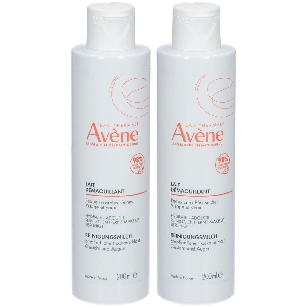 Twee witte flessen met rode tekst. Opschrift: Avène, reinigingsmelk voor gevoelige huid.