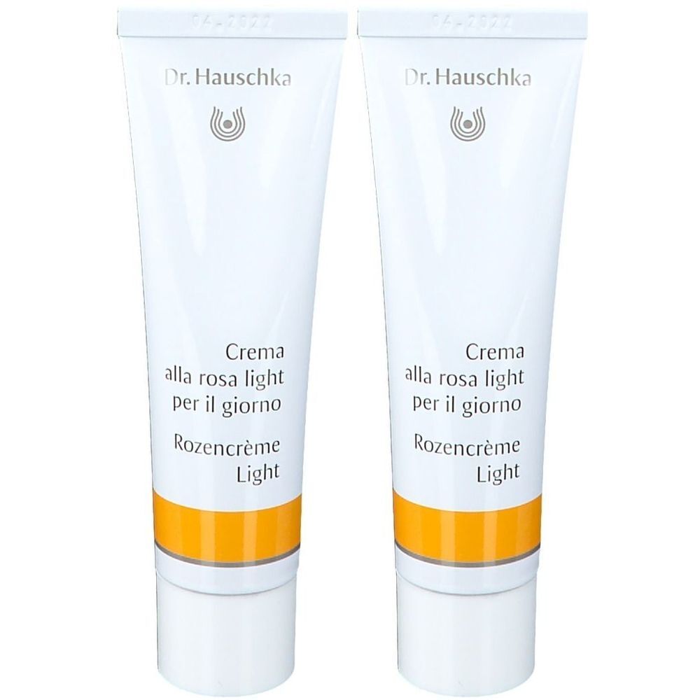 Twee tubes crème. Opschrift: Dr. Hauschka, Crema alla rosa light per il giorno, Rozencrème Light.