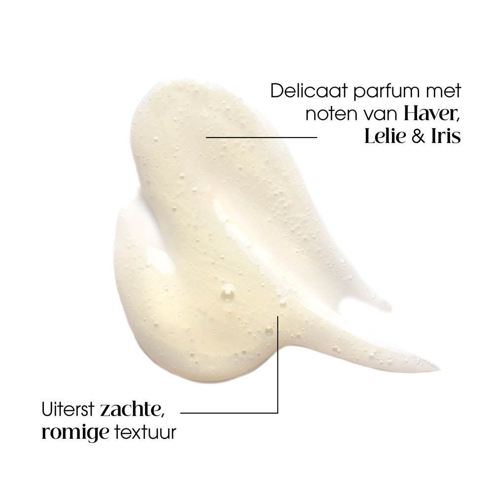 Close-up van shampoo textuur. Lichtgeel. Tekst: Parfum délicat met noten van Haver, Lelie & Iris. Uiterst zachte.