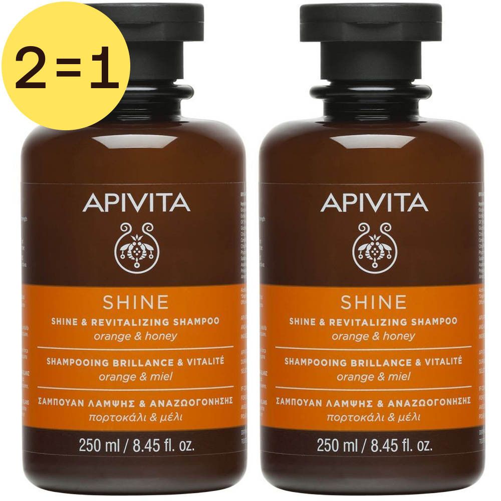 Deux flacons de shampooing marron avec bouchon noir. Inscriptions: APIVITA, SHINE, 250 ml. Autocollant jaune: 2=1.