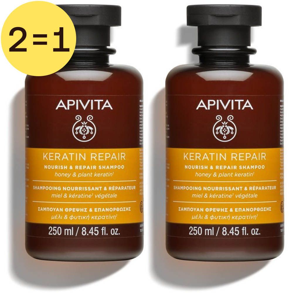 Twee bruine shampoo flessen met zwarte dop. Opschrift: Apivita, Keratin Repair, 250 ml. Gele sticker met "2=1".