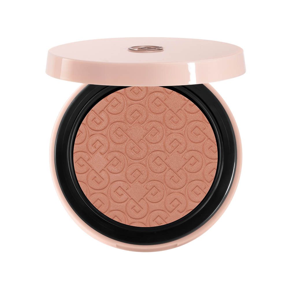 Poudre compacte blush ronde ouverte, couvercle rose. La poudre est terracotta avec un motif.
