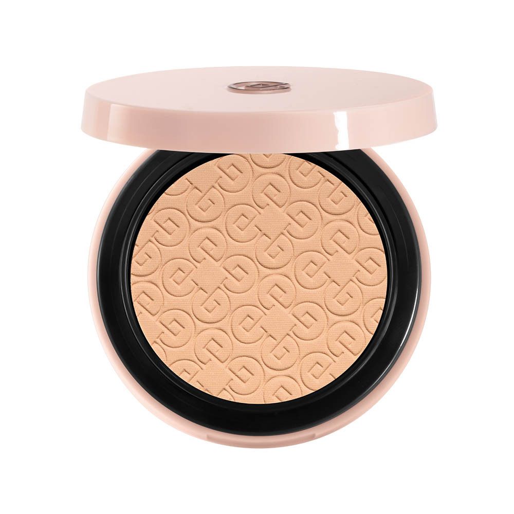 Poudre compacte ouverte. Poudre beige, couvercle rose. Logo sur la poudre.