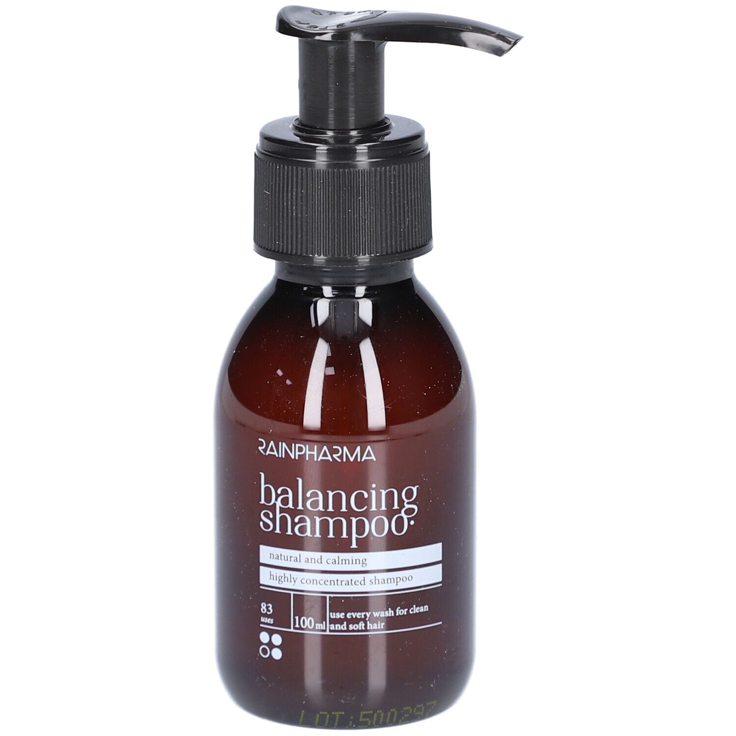 Bruine fles met zwarte pomp. Opschrift: Rainpharma balancing shampoo. Natuurlijke en kalmerende shampoo.