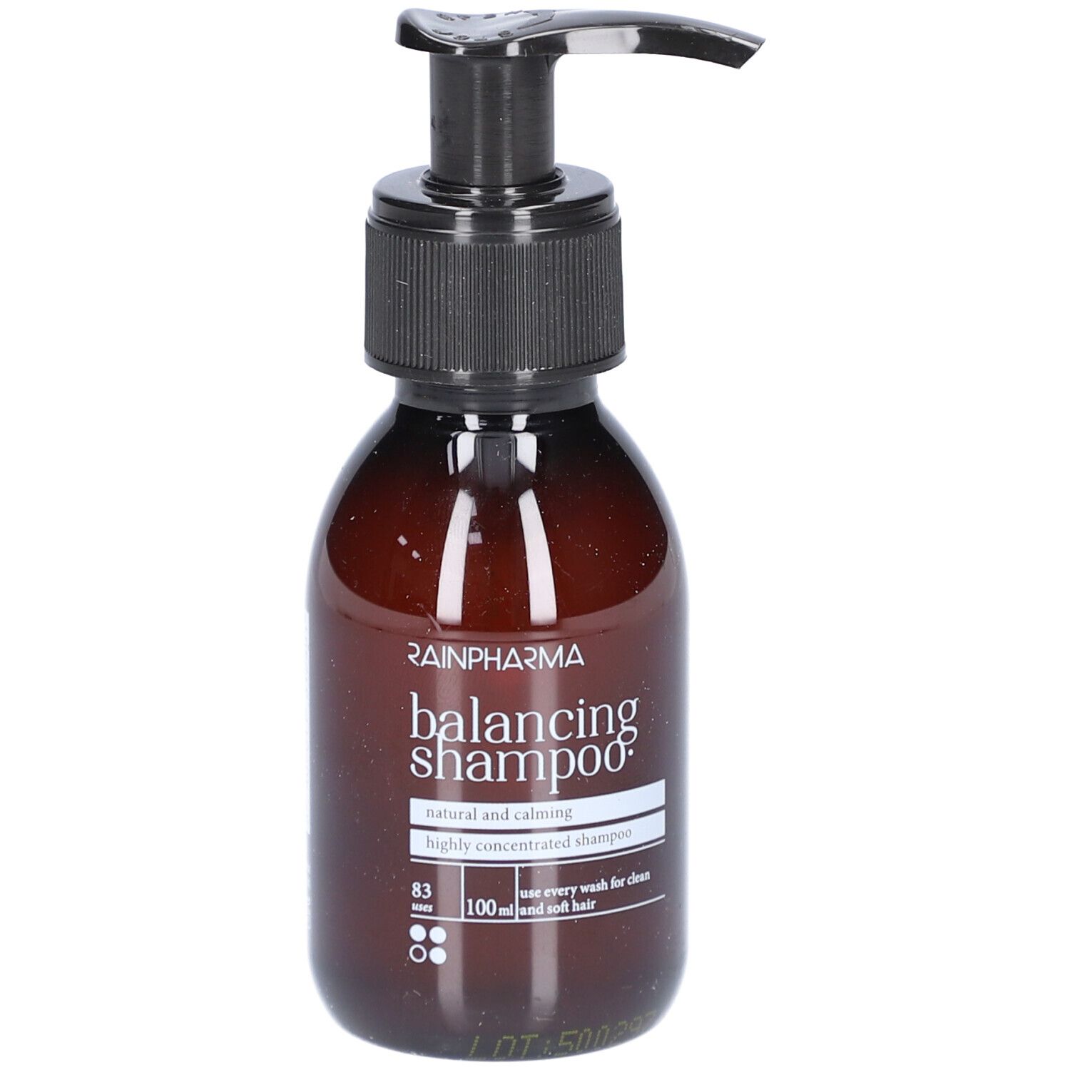 Bruine fles met zwarte pomp. Opschrift: Rainpharma balancing shampoo. Natuurlijke en kalmerende shampoo.