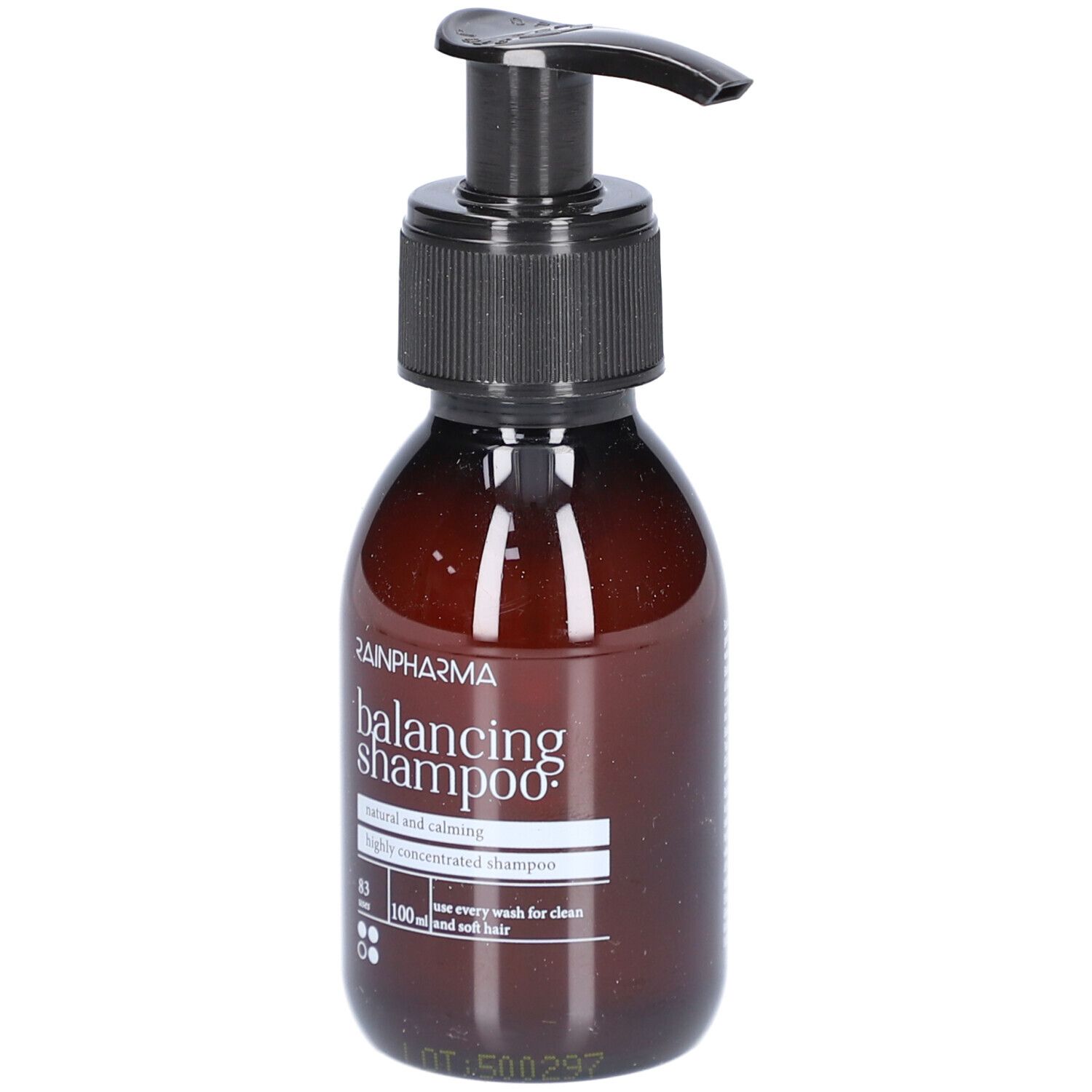 Bruine fles met zwarte pomp. Opschrift: Rainpharma balancing shampoo. Natuurlijke en kalmerende shampoo.