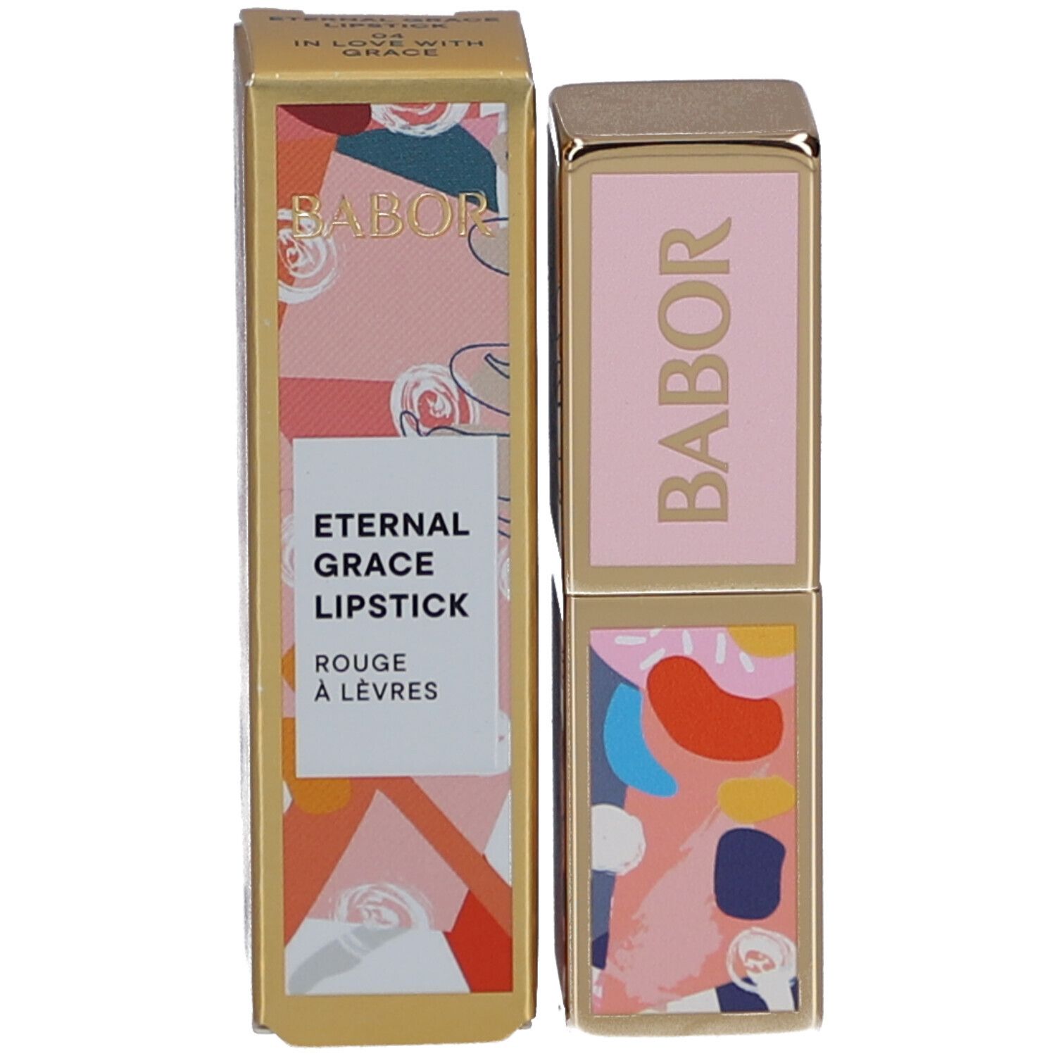 Rouge à lèvres et emballage. Rouge à lèvres doré avec couvercle rose et logo Babor. Emballage avec texte et motif.