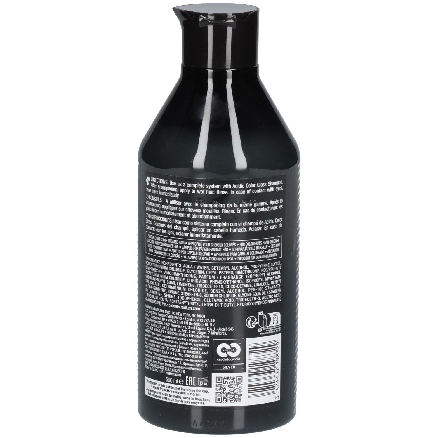 Achterkant van een zwarte fles. Tekst met ingrediënten en instructies. REDKEN-logo en recyclingsymbool.
