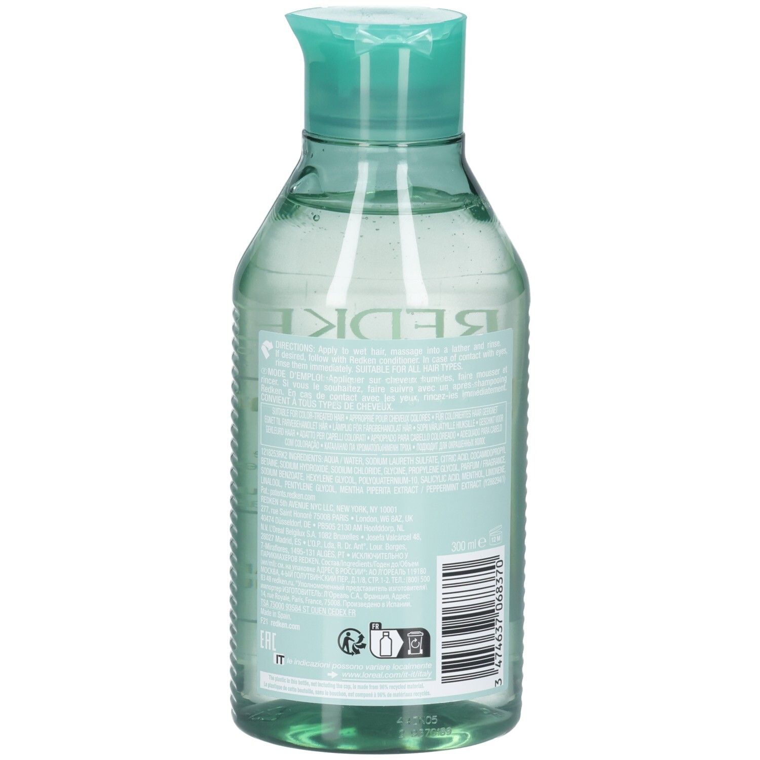 Transparante fles met turkooizen klapdop, gevuld met lichtgroene vloeistof. Etiket met tekst en barcode.