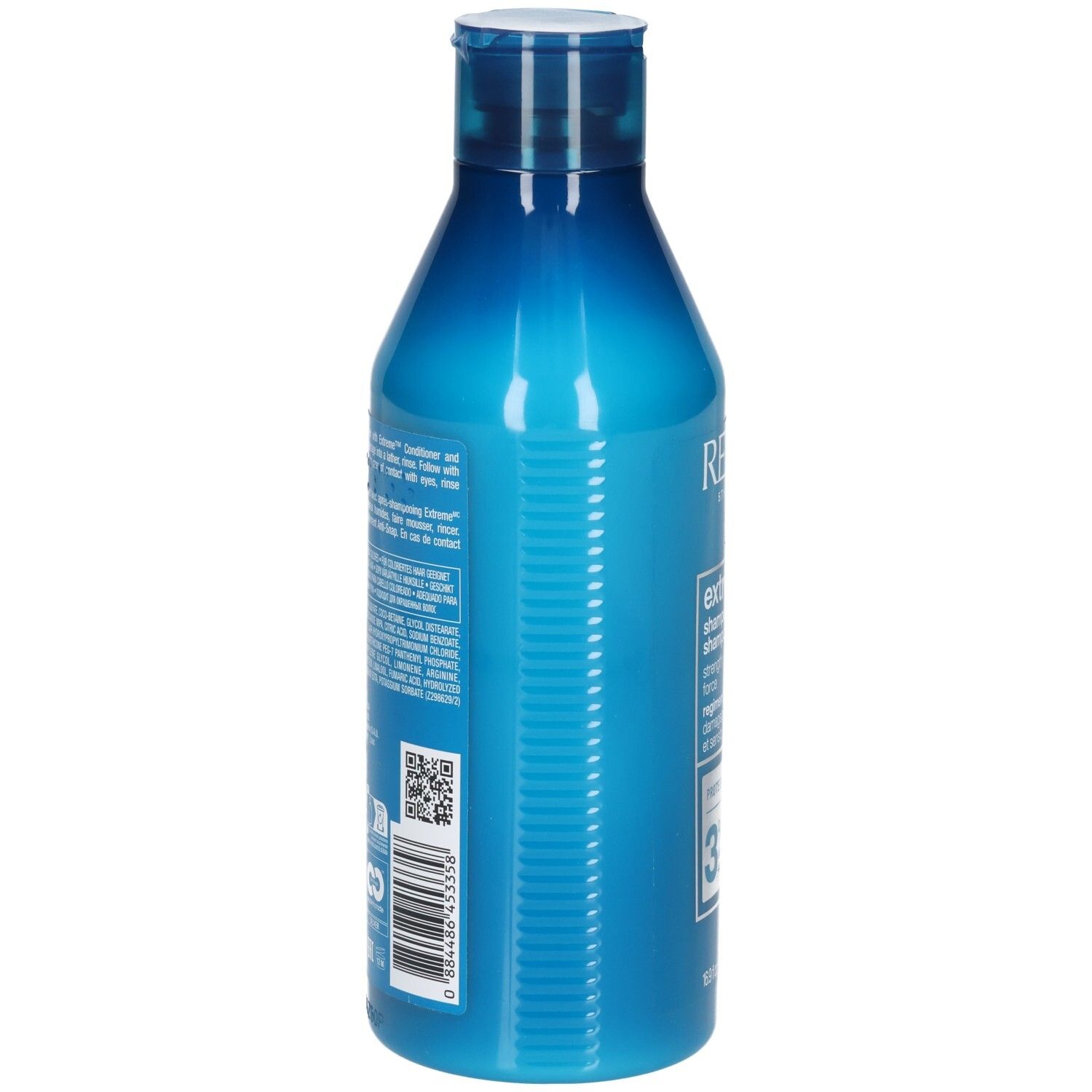 Blauwe shampoo fles. Achterkant met tekst en barcode. Bevat informatie over ingrediënten en fabrikant.