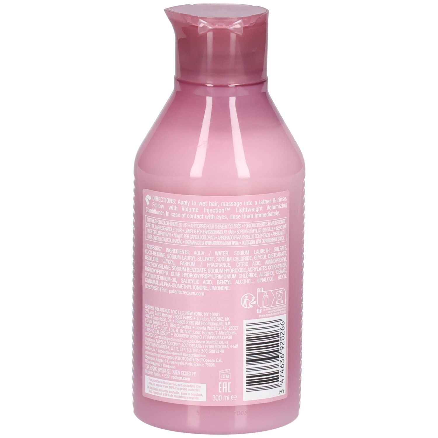 Dos d'un flacon de shampooing rose avec texte. Code-barres et informations du fabricant visibles.