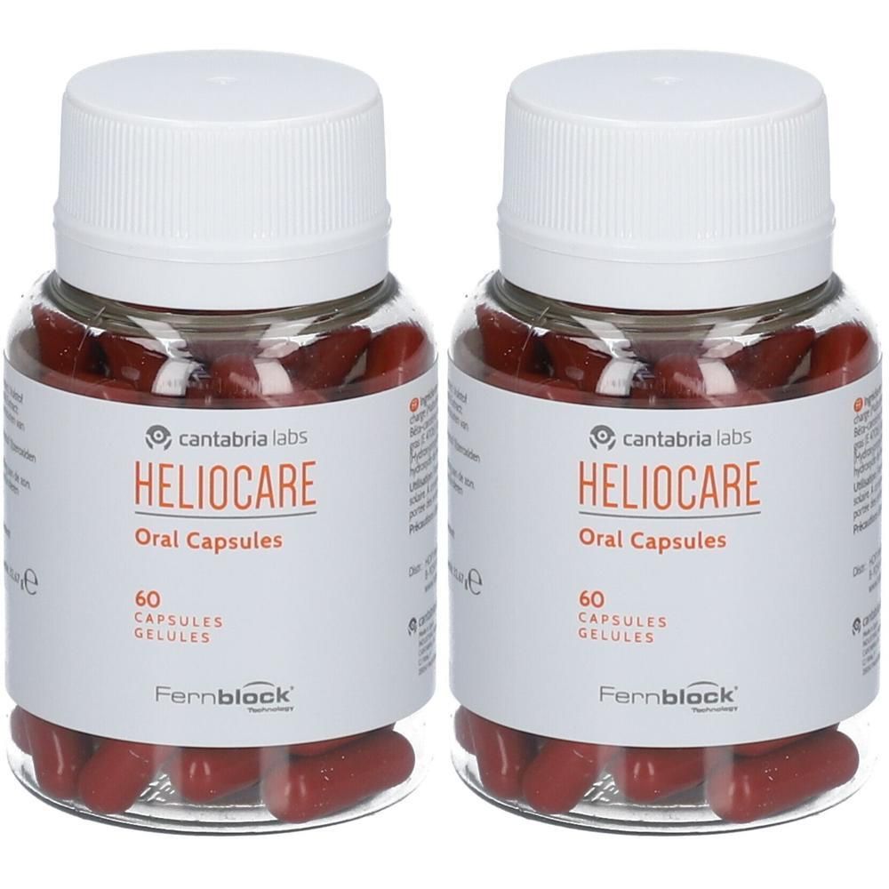 Twee flessen Heliocare Oral Capsules. Transparante flessen met witte doppen en etiketten. Rode capsules zichtbaar.