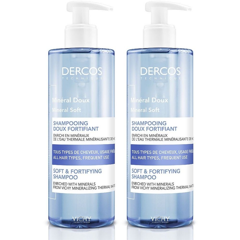 Twee flessen Vichy Dercos shampoo. Blauwe, transparante flessen met witte pomp. Tekst: Dercos, Mineral Doux, Shampooing Doux Fortifiant.