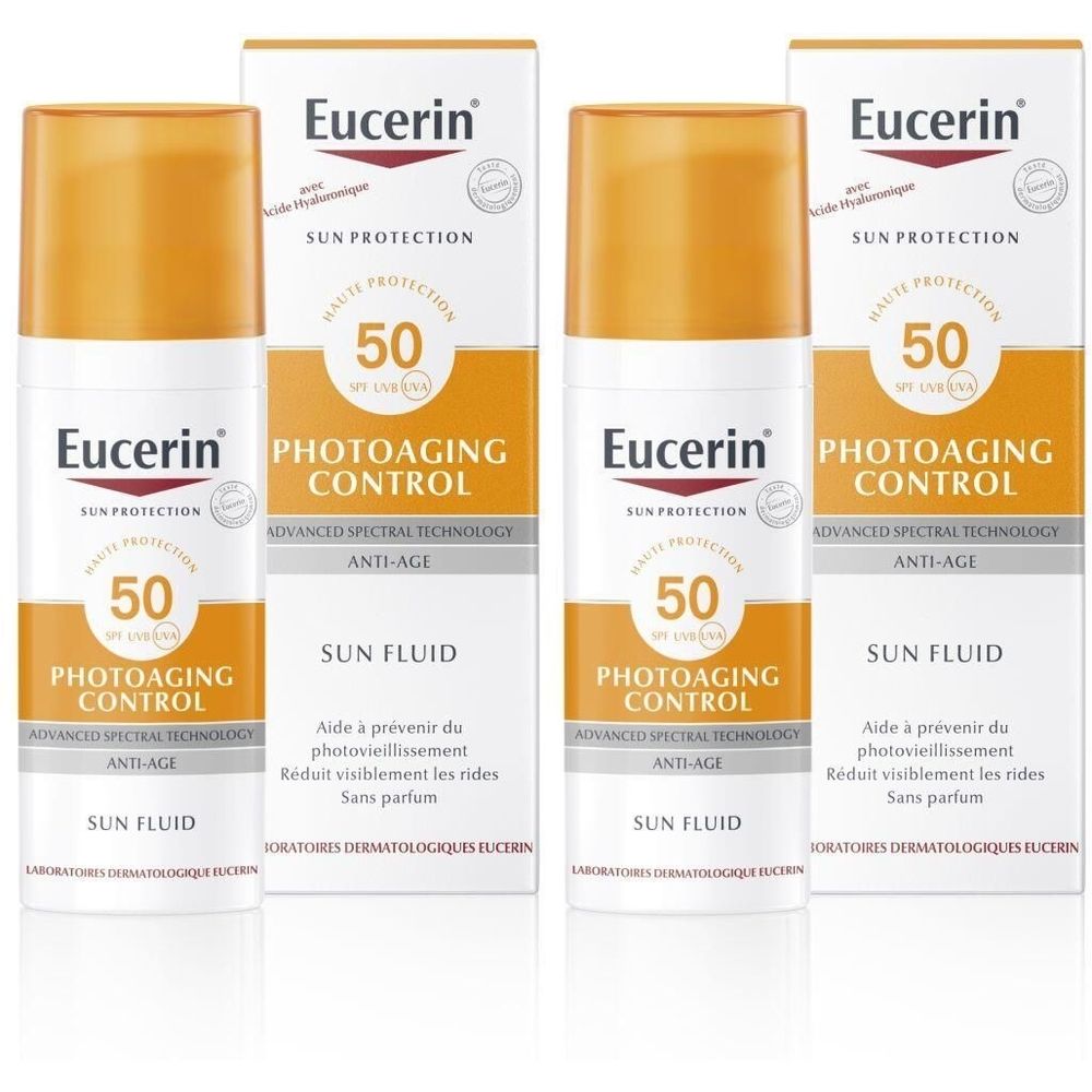 Meerdere flessen en verpakkingen van Eucerin Photoaging Control Sun Fluid SPF 50. Witte flessen met oranje doppen en verpakkingen.