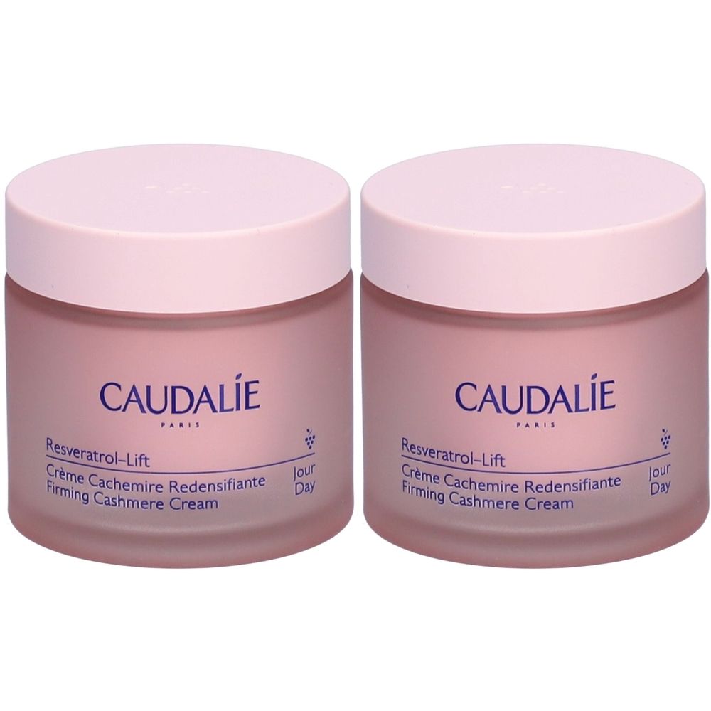 Twee roze crèmetiegels met deksels. Op de potten staat "CAUDALIE Resveratrol-Lift Crème Cachemire Redensifiante Firming Cashmere Cream".