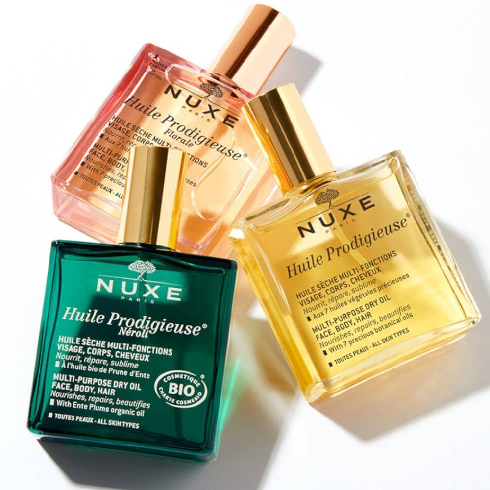 Trois flacons : vert, jaune et rose. Inscription : NUXE Huile Prodigieuse®. Huile sèche multi-fonctions.