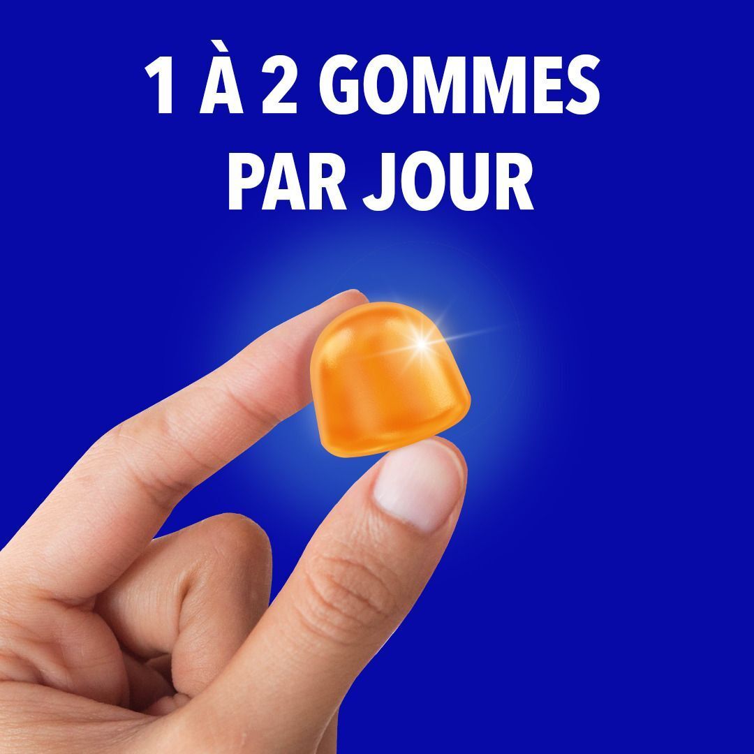 Gomme orange avec les textes : 8 vitamines, magnésium, bactéries. Fond bleu.