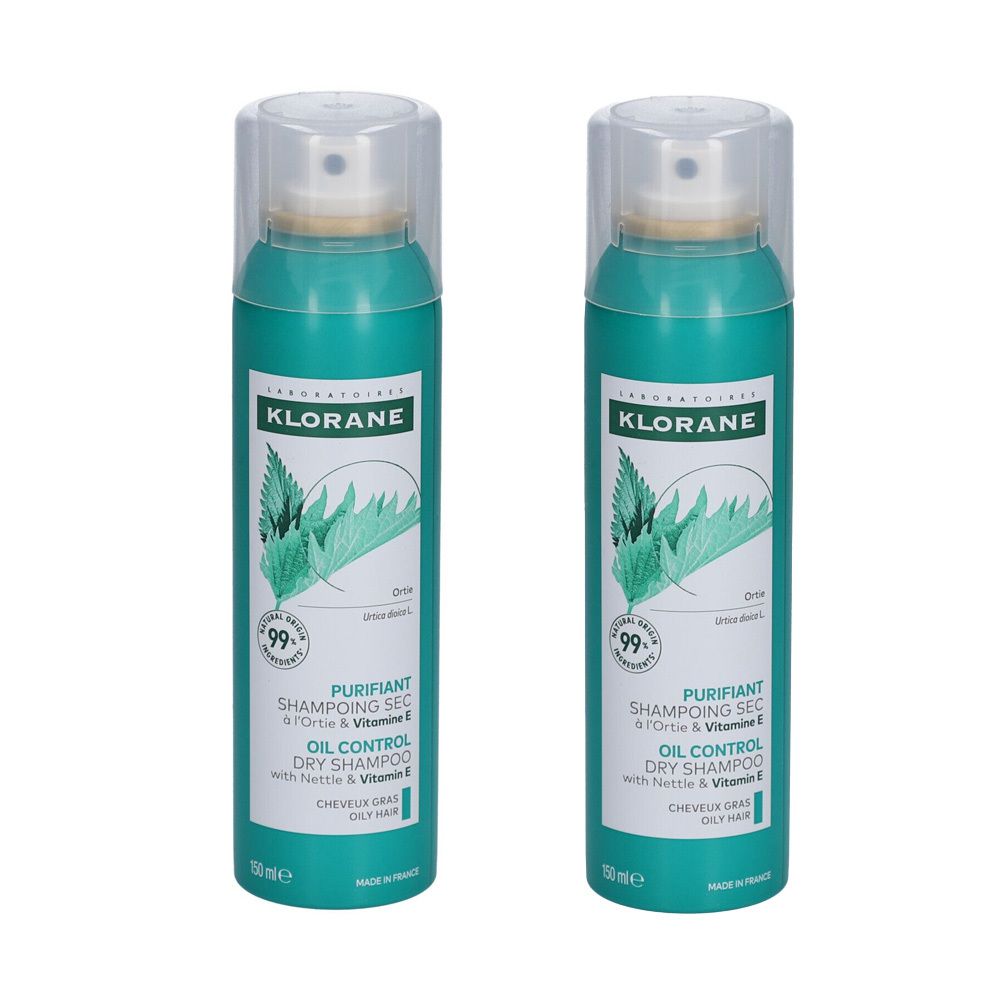 Twee groene spuitbussen met wit etiket. Opschrift: Klorane Droogshampoo met brandnetelextract.