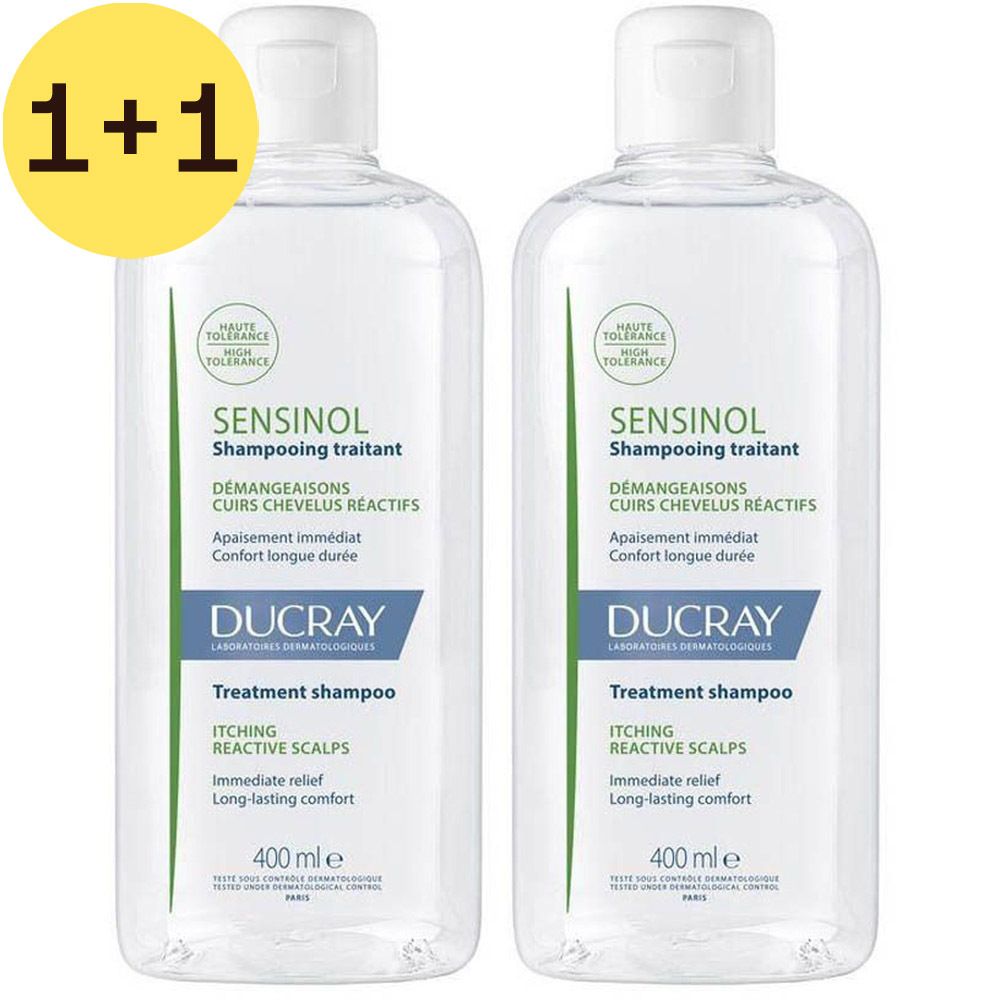 Twee transparante shampoo flessen met witte dop. Opschrift: Sensinol, Ducray. Gele cirkel met "1+1".