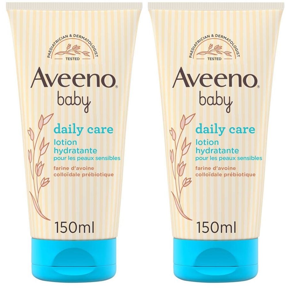 Deux tubes de lotion Aveeno Baby Daily Care. Inscription: 1+1 GRATUIT. Bouchons bleus, fond beige.