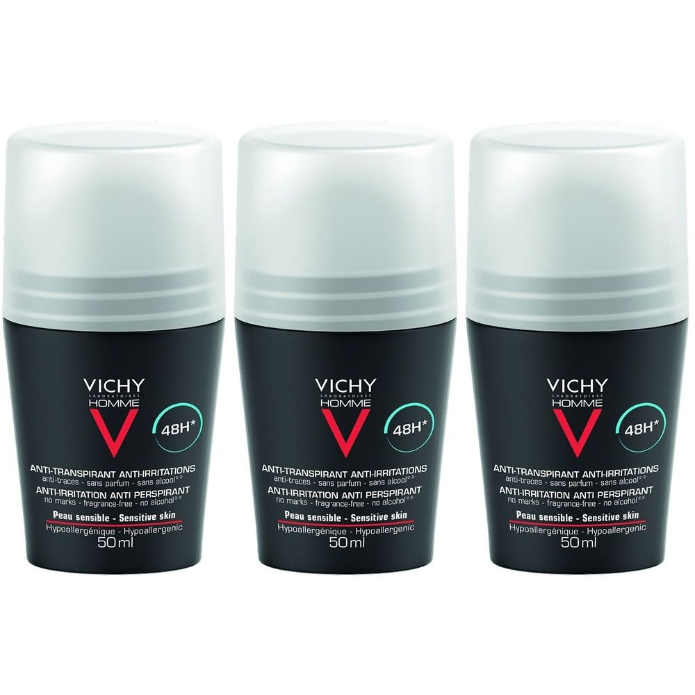 Trois roll-on déodorants Vichy Homme. Flacons noirs avec bouchon blanc. Visible : logo, texte, 48H, pour peaux sensibles.