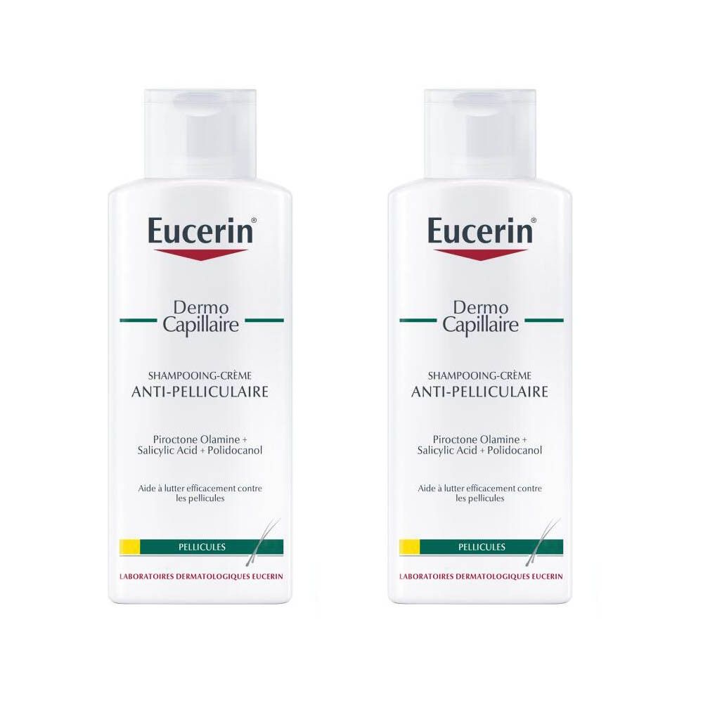 Deux flacons blancs de Eucerin DermoCapillaire Shampooing-Crème Anti-Pelliculaire. Écriture rouge Eucerin, bande verte, nom du produit.