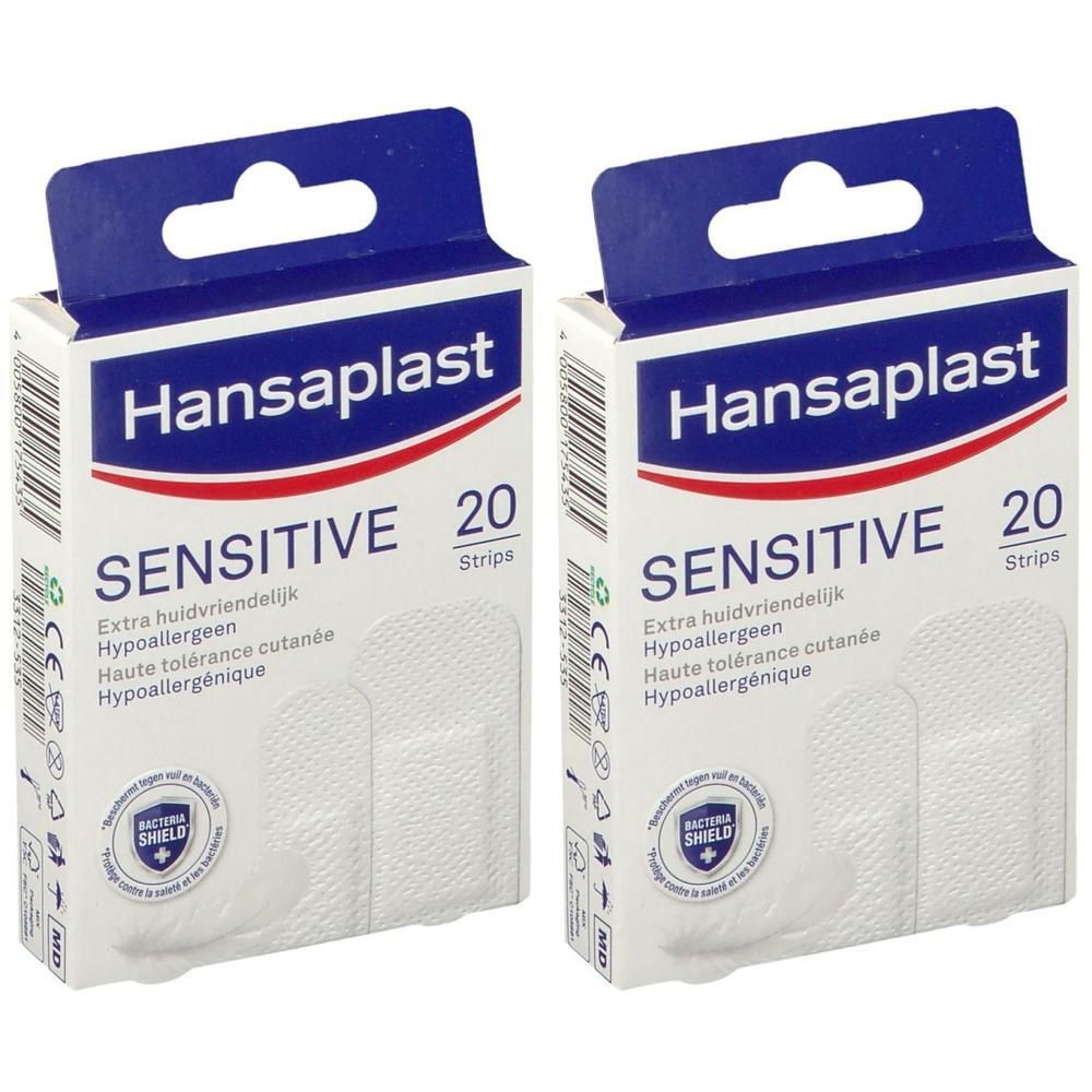 Twee dozen Hansaplast SENSITIVE pleisters. Witte pleisterstrips in geopende dozen. Opschrift: SENSITIVE, 20 Strips.