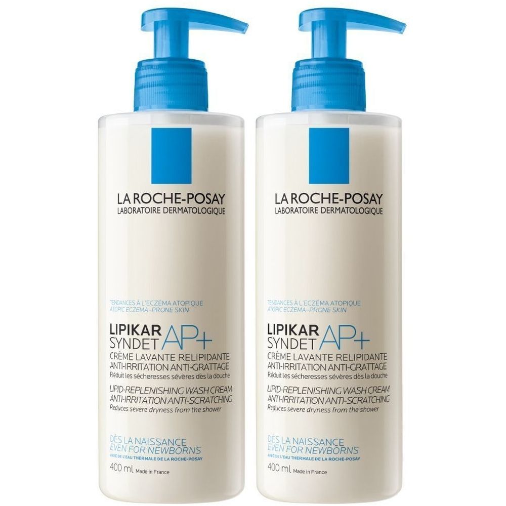 Twee flessen La Roche-Posay Lipikar Syndet AP+ met blauwe pompjes. Tekst: Crème Lavante Relipidante, voor een zeer droge huid.